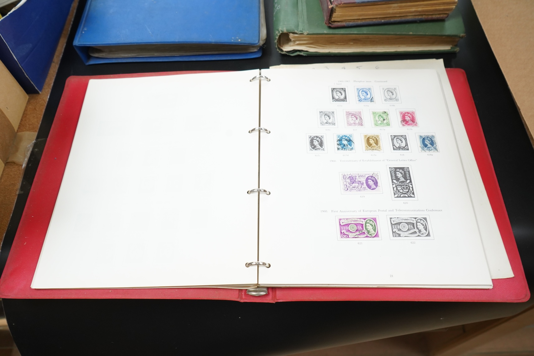 Four stamp albums including a first day cover album